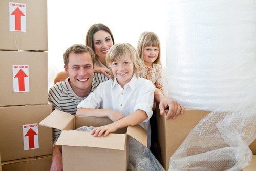 Professional movers carrying furniture in a Kingston apartment building
