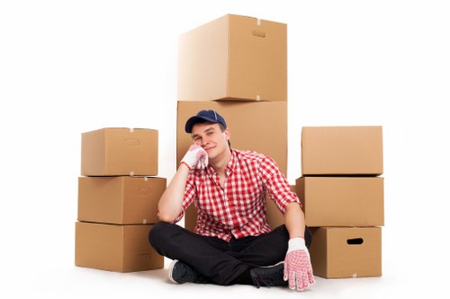 Packed boxes and furniture ready for a Kingston removal van